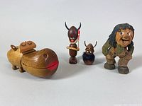 Group photo showing the teak hippo box with three Danish wooden figurines including tribal characters and a Viking figure.