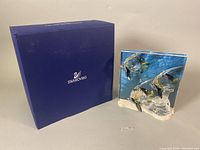 The full Swarovski blue box and crystal figurine side by side showing the contents of the lot.