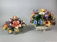 Two porcelain floral bouquets side by side on neutral background showing size and detail.