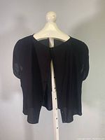 Black Giorgio Armani ladies blouse displayed on a white mannequin, showing the front with short puffed sleeves and lightweight fabric.