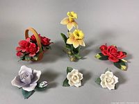 All six Andrea by Sadek ceramic flower figurines including two white roses, one red rose, a pair of yellow daffodils, and a small basket with red flowers