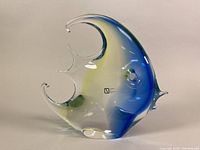 Front and side view of the blown glass angel fish sculpture showing its shape and color pattern.
