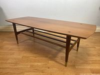 Straight-on front view showing surfboard profile, legs and lower shelf