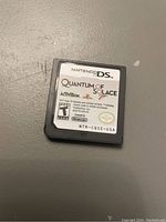 Image shows a close-up of the Nintendo DS game cartridge for Quantum of Solace, with clear view of the label and branding.