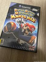 Photo of the Dance Dance Revolution Mario Mix game case for Nintendo GameCube showing front artwork with Mario dancing.