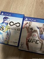 Photo of two PS4 game cases: Mark McMorris Infinite Air and EA Sports UFC.