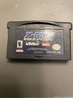 Photo of the Game Boy Advance cartridge for X-Men Reign of Apocalypse showing the front label with branding and rating details.