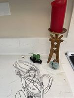 Photo showing the full lot with Asian ink artwork on transparency, green lion figurine, perfume bottle, and metal candle holder with red candle