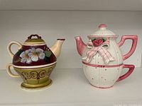 Two mini teapot and teacup sets side by side showing overall design and size.