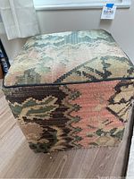 Front and side view showing patterned upholstery and black piping edging