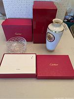 Overview of all three items—crystal bowl, bud vase, stationery box—with original red Cartier boxes