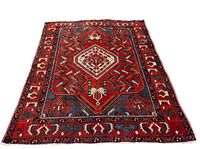 Full view of the semi-minimal Bakhtiar rug showing central medallion and borders in red lacquer and accent colors.