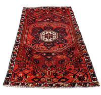 Full view of Persian Zanjan rug showing main geometric pattern and border symbols in lacquered red and dark orange.