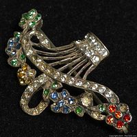 Front view of sterling silver floral brooch with multicolor rhinestones showing the detailed flower and basket design.