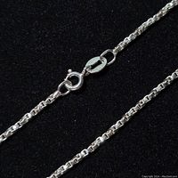 Close-up view of the bracelet chain and spring ring clasp showing the silver mark.