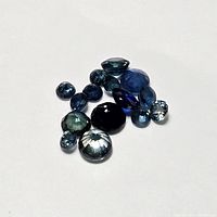 Top-down view of the loose sapphire gemstones group showing various sizes and cuts.