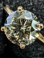 Close-up of round brilliant diamond and six-prong setting