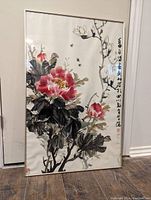Framed Chinese floral artwork with calligraphy, glass cracked in bottom right corner.
