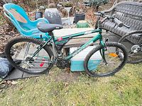 Side view photo of the green CCM Ice mountain bike showing the full bike, tires, seat, frame decal, and gear system.