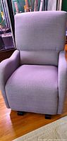 Front view of the grey upholstered rocking chair showing full seating surface and backrest