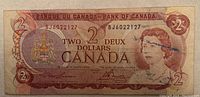 Front of 1974 Canadian two dollar bill showing Queen Elizabeth II portrait and serial number BJ6022127.