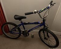 Side view of the entire blue Supercycle Clutch 20 inch bicycle showing frame, tires, seat, and handlebars.