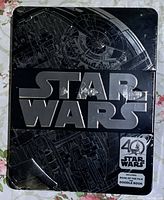 Front view of the sealed Star Wars 40th Anniversary tin showing the Star Wars logo and 40th Anniversary emblem.