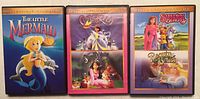Front view of three GT Media Collectible Classics double feature DVD cases: The Little Mermaid; Cinderella and Snow White; Sleeping Beauty and Beauty And The Beast.