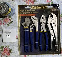 Photo showing unopened 4-piece Mastercraft pliers and wrench set in original packaging with a soda can for scale.