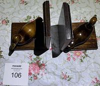 Top view of both wooden duck bookends showing detail of carved ducks and wood finish.