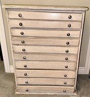 Front view of the ten-drawer cabinet showing full drawer configuration and metal knob pulls
