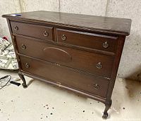 Full front view of the antique walnut dresser with four drawers and original handles.