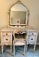 Full front view of the antique white wash vanity with fixed mirror and matching chair