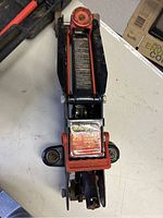 Top view of the floor jack showing red and black colors with visible Team Mechanic label indicating 2 1/2 ton capacity.