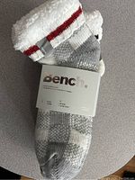 Photo of 2 pairs of women's socks from Bench brand, one pair gray and white knit with fuzzy white cuff and red stripe detail, labeled new