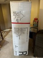 Tall boxed packaging of the Christmas tree marked as a quashape Montana Fir tree model, weighing 24 lbs