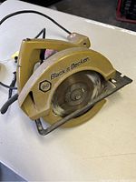 Overall side view showing saw body, blade, and power cord.