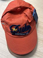 Orange Duken Equipment Ltd. baseball cap with crown logo embroidered on front.