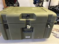 Front view of olive green Zero rugged transport case with latches and locking mechanism.