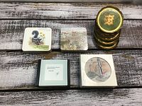 Photo showing all five sets of coasters arranged on a wood surface.