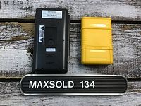 Back view of Sony Watchman handheld TV and yellow Zircon Dimension Pro 4.0 placed side by side on wooden surface