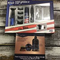 Photo showing the Barbasol 15-piece ultimate grooming set with trimmer, accessories, and King C. Gillette beard grooming kit box with beard balm and wash visible.