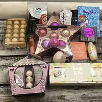 Photo of complete set displaying star-shaped tin with bath bombs, French Lavender Coffret de Bain box, Bride to Be soap box, collagen eye mask, wooden massager, face cleansing cloth, and other bath items.