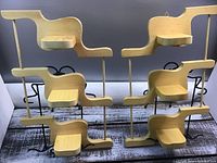 Front view of the two identical wooden wall hanging shelves with three tiers, showing design and structure.