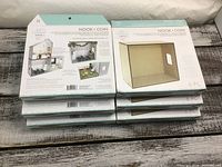 6 unopened Nook Coin DIY Modern Mini storage boxes stacked on wooden floor.