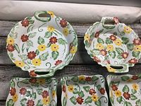 Five ceramic Temp-tations dishes with floral pattern, two round handled and three square dishes.