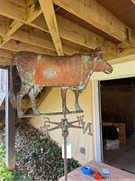 Overall profile under deck showing cow silhouette and patina