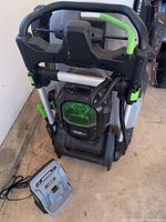 Folded mower with charger positioned in front