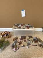 Full view of porcelain miniature town buildings with plastic container and model trees
