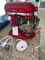 Front view of mixer with bowl and attachments on countertop